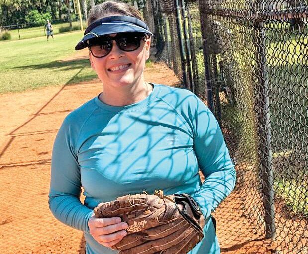 Woman wearing a softball glove