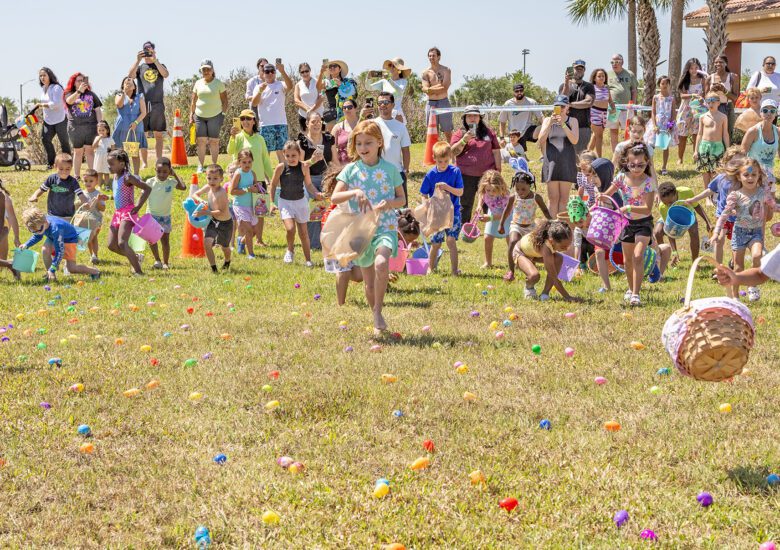 Kids run into the field to begin the egg hunt