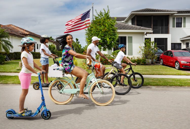 Ave Maria family residents ride their bikes in their neighborhood