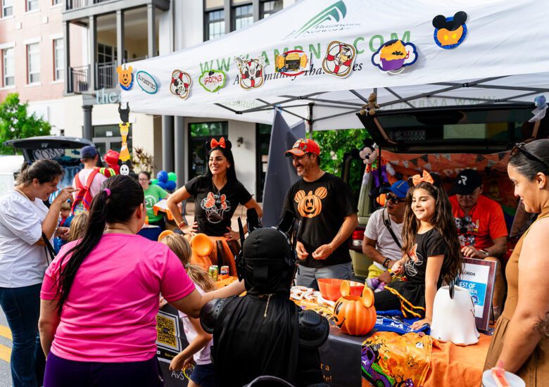Family with trunk passes out candy to event participants
